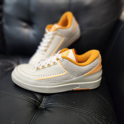 Air Jordan 2 Retro Low Craft Melon Tint sneakers with orange accents on tongue, heel, and outsole, SKU DV8759-600